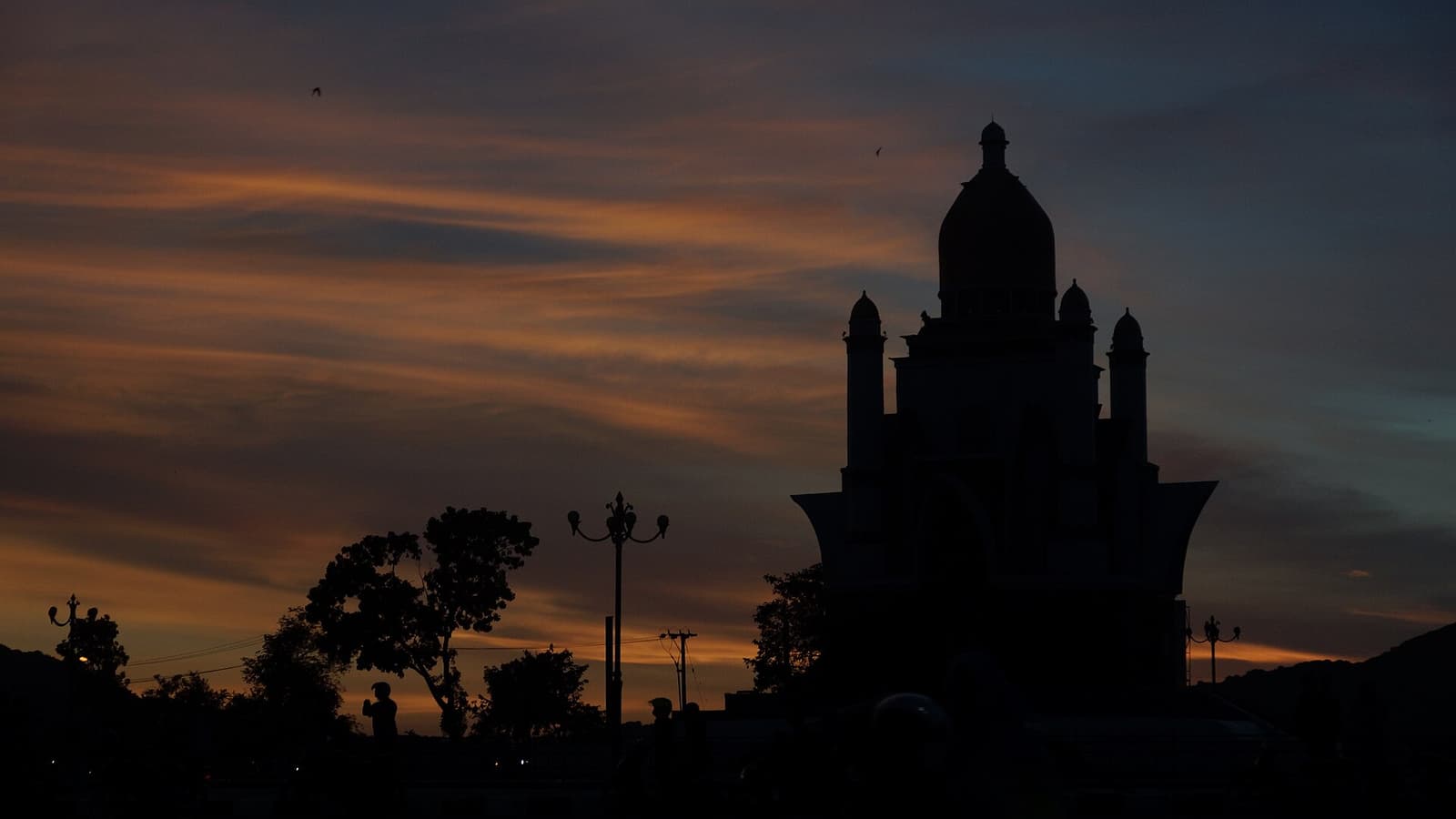 A mosque silhouetted at sunset on Lombok, the “Island of a Thousand Mosques”